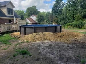 A swimming pool project being built in a backyard.
