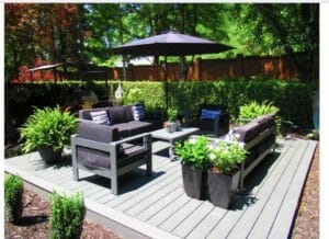 A gallery of a patio with black furniture and an umbrella.