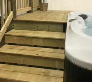         This description showcases a hot tub with steps leading up to it, perfect for your project.