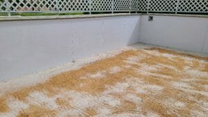 A sand filled backyard with a fence featured in our project gallery.