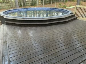Project: A gallery showcasing a wooden deck with an inground pool.