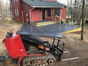 A red bulldozer is parked in front of a house, adding an artistic touch to the project.