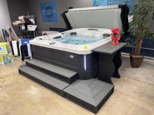In a showroom gallery, a hot tub is elegantly displayed on a table.