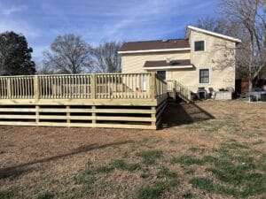 Project: A wooden deck with a wooden railing.