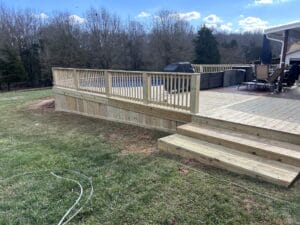 Project: A wooden deck with steps and railings is a stunning addition to any home. Crafted from high-quality materials, this deck showcases expert craftsmanship and thoughtful design. The steps provide easy access to