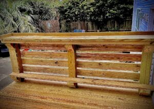 A wooden bench in a deck gallery.