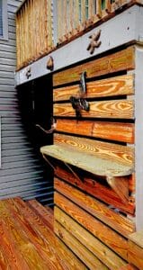 Project: A wooden deck with a surfboard on it.