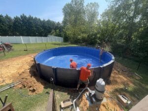 Project Description: A backyard swimming pool being built.
